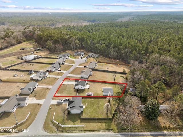 birds eye view of property with a forest view