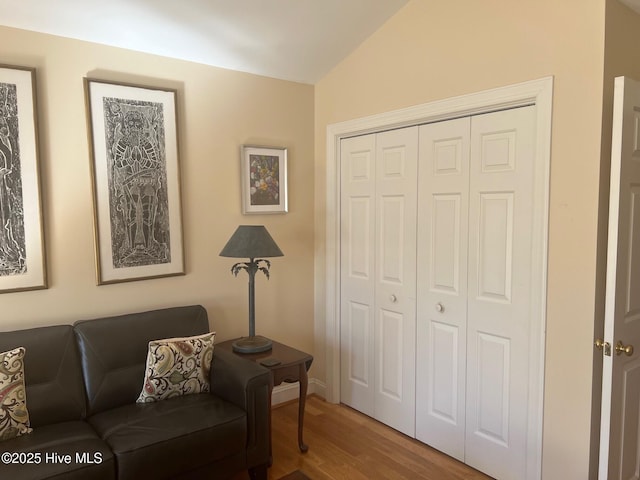 living area with lofted ceiling and wood finished floors