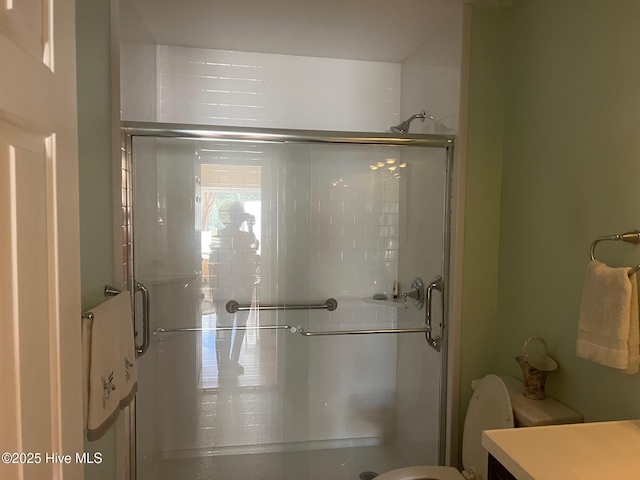 full bath featuring vanity, a shower stall, and toilet