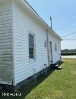 view of property exterior with a yard