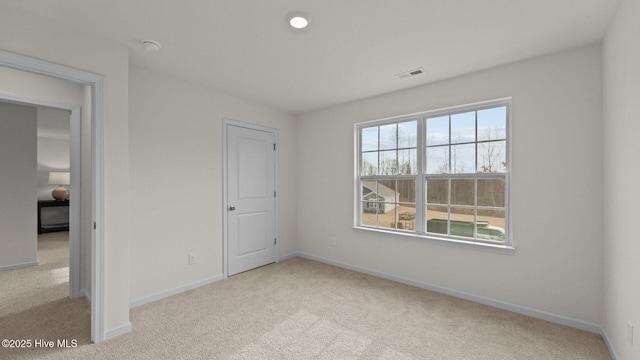 unfurnished bedroom with baseboards, visible vents, and carpet floors