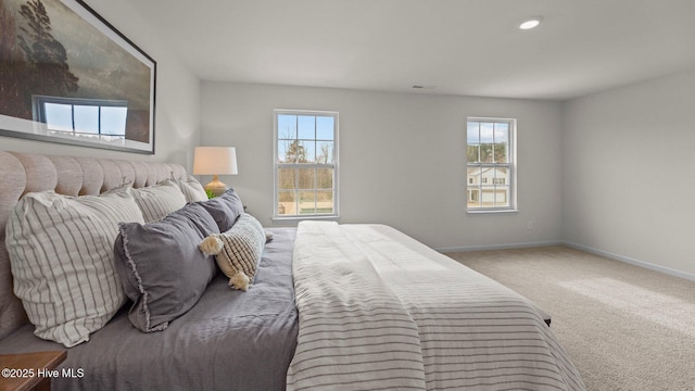 bedroom with multiple windows, visible vents, baseboards, and carpet floors