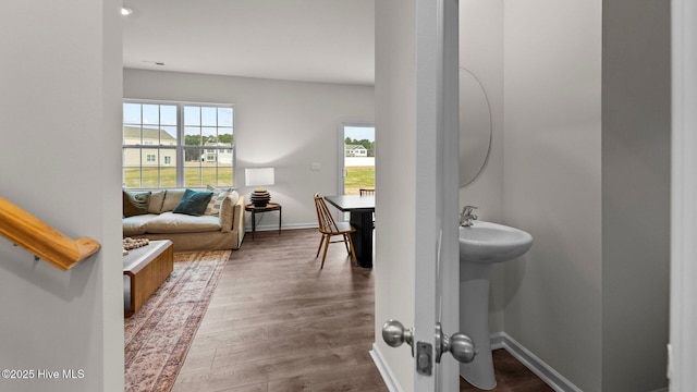 bathroom with baseboards and wood finished floors