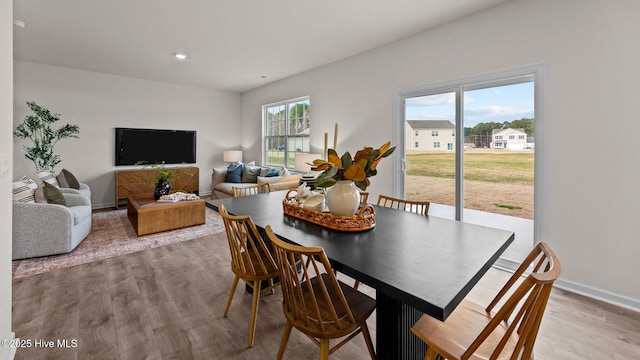 dining room with light wood-style flooring, recessed lighting, and baseboards