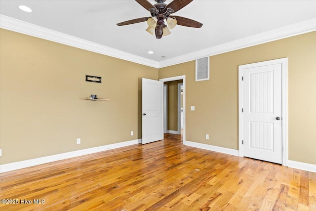 unfurnished bedroom with crown molding, light wood-style flooring, baseboards, and visible vents