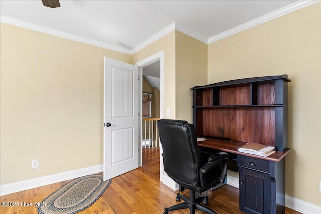 home office featuring baseboards, wood finished floors, and crown molding