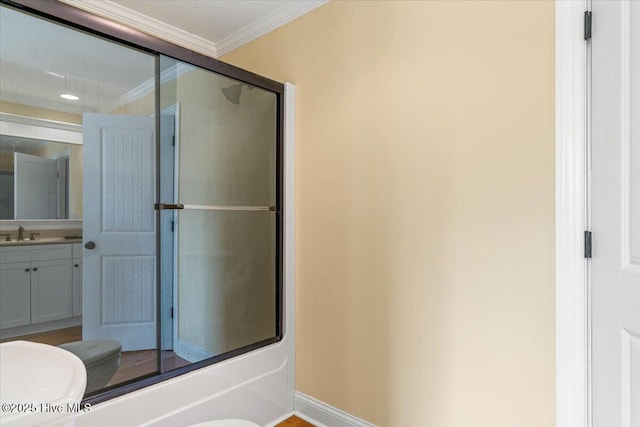 full bathroom featuring shower / bath combination with glass door, toilet, vanity, and ornamental molding