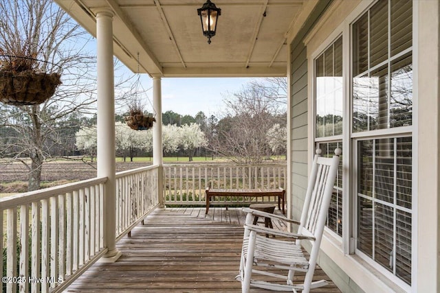 wooden terrace featuring covered porch