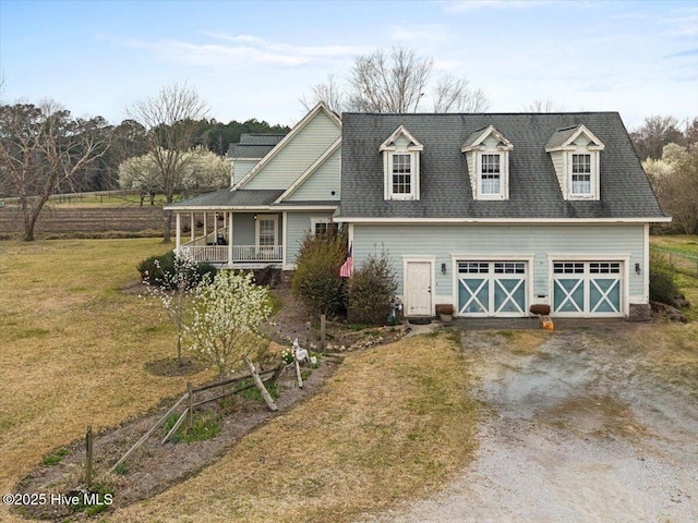 view of front of home with driveway, covered porch, a front yard, a shingled roof, and a garage