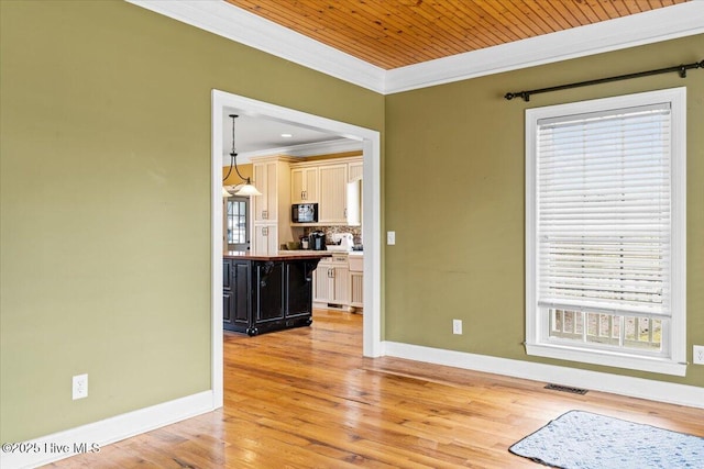 interior space featuring baseboards, visible vents, light wood finished floors, and ornamental molding