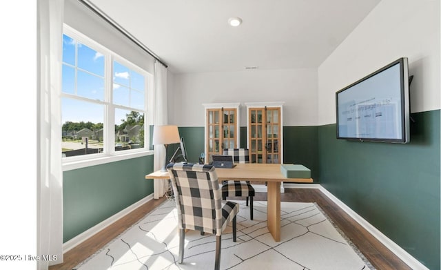 office with visible vents, baseboards, and wood finished floors