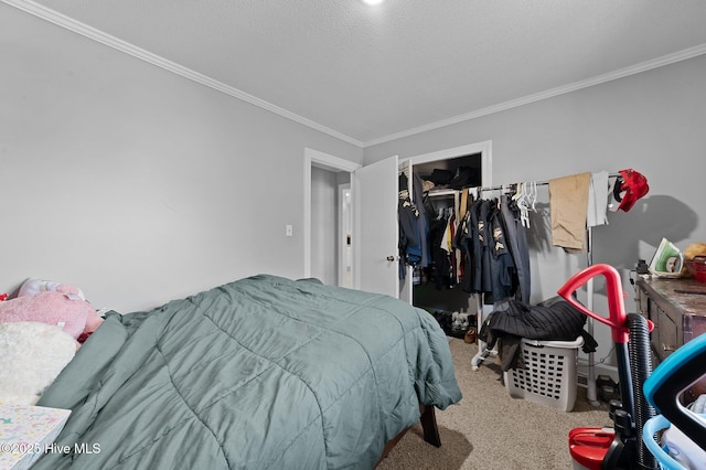 carpeted bedroom featuring a closet, a textured ceiling, a walk in closet, and ornamental molding