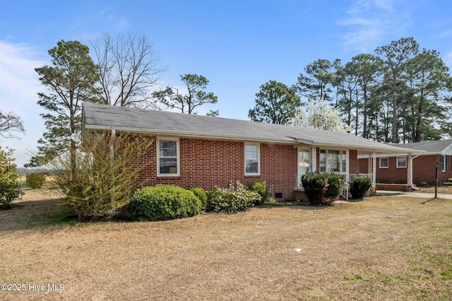 view of front of house with crawl space, brick siding, and a front lawn