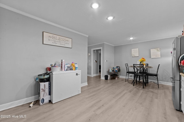 dining space with recessed lighting, light wood-style flooring, crown molding, and baseboards