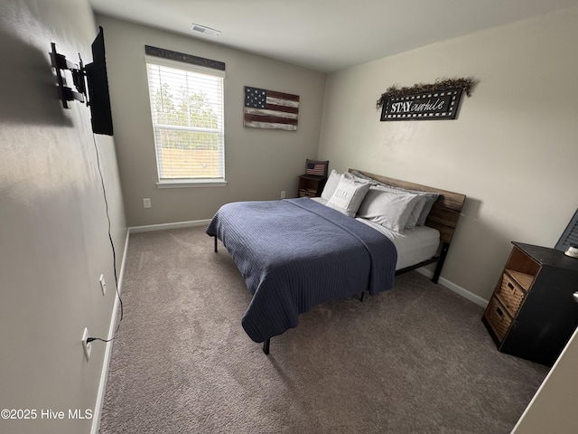 carpeted bedroom featuring visible vents and baseboards