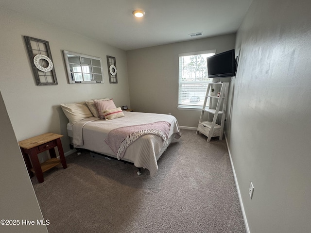 bedroom with visible vents, dark carpet, and baseboards