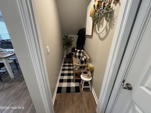 hall with dark wood-style floors and baseboards