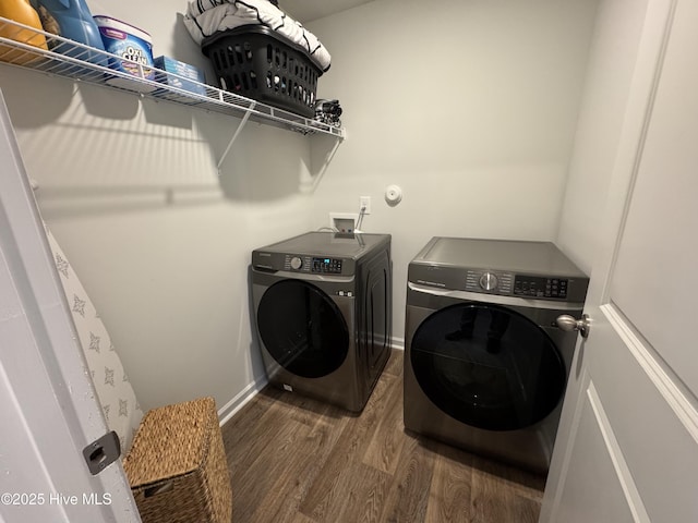 laundry area featuring laundry area, wood finished floors, independent washer and dryer, and baseboards