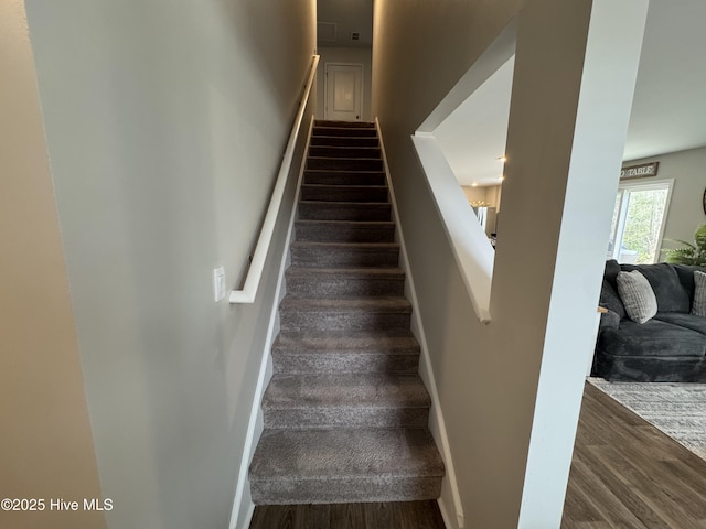 stairs featuring baseboards and wood finished floors