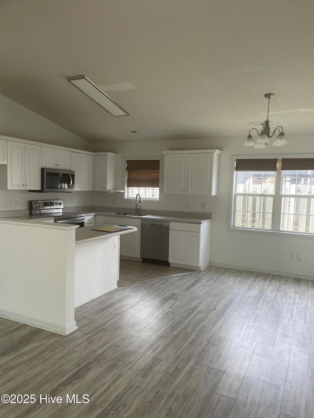7223 Konlack Ct, Wilmington, NC 28411 - kitchen with light wood-style flooring, white cabinetry, and appliances with stainless steel finishes