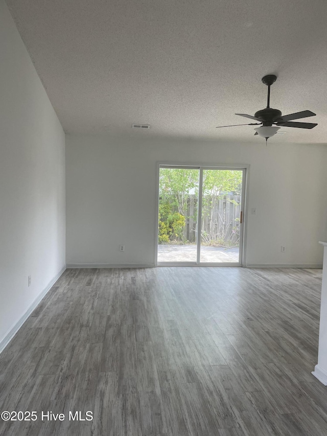 7223 Konlack Ct, Wilmington, NC 28411 - empty room with baseboards, a ceiling fan, wood finished floors, and a textured ceiling