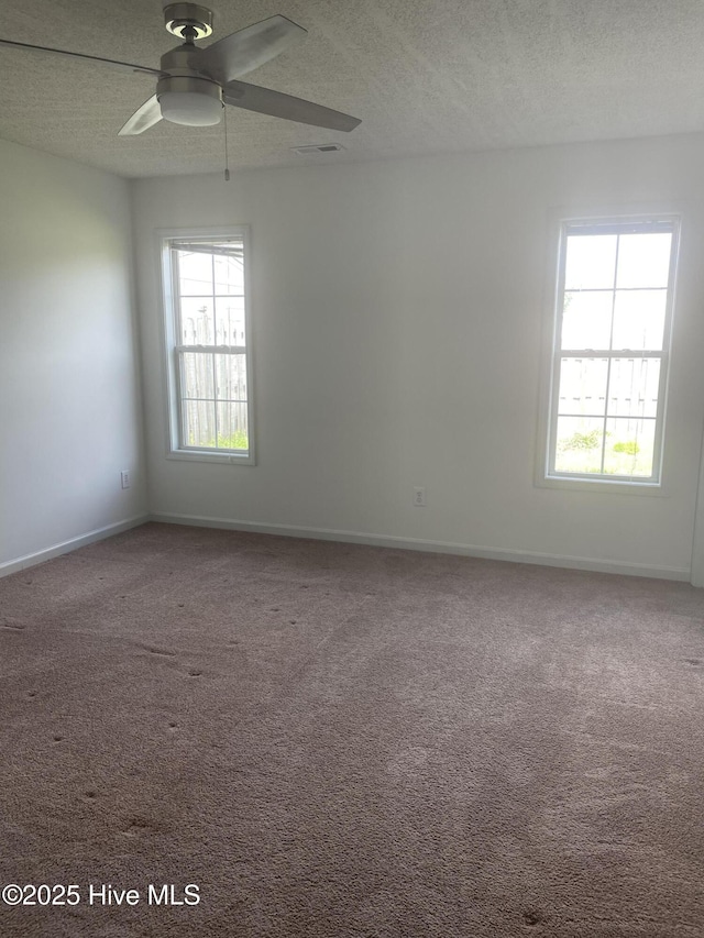 7223 Konlack Ct, Wilmington, NC 28411 - carpeted spare room featuring a textured ceiling, baseboards, and a ceiling fan