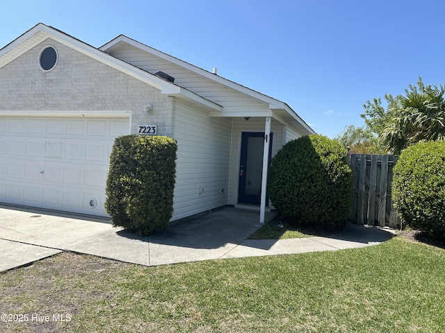 7223 Konlack Ct, Wilmington, NC 28411 - single story home featuring brick siding, a front lawn, fence, and a garage