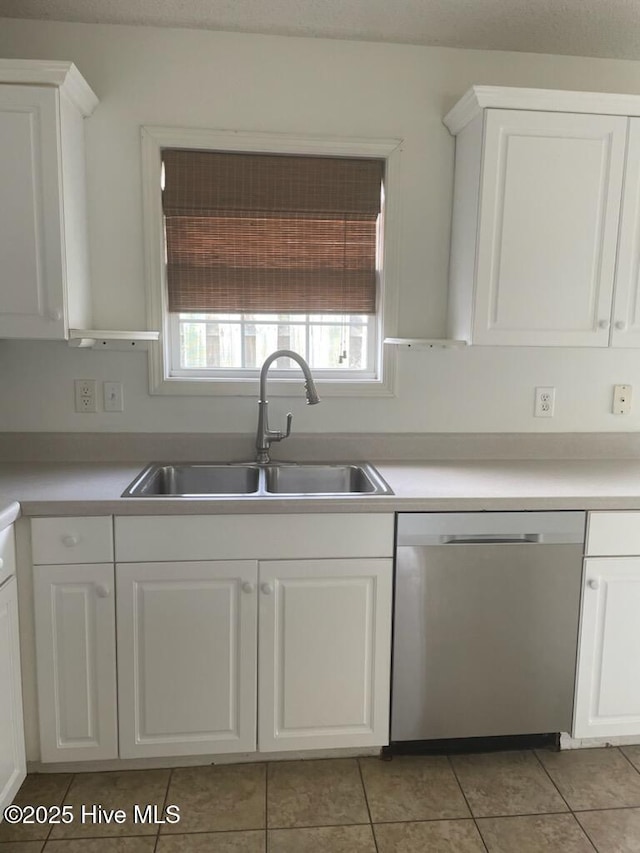 7223 Konlack Ct, Wilmington, NC 28411 - kitchen with a sink, stainless steel dishwasher, light tile patterned flooring, and white cabinets