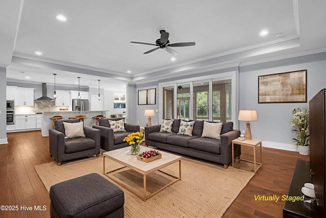 1115 Eldora Ct, Leland, NC 28451 - living room featuring a raised ceiling, ceiling fan, dark wood-style flooring, recessed lighting, and crown molding