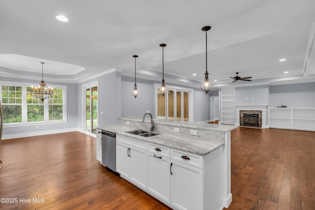 1115 Eldora Ct, Leland, NC 28451 - kitchen with a sink, stainless steel dishwasher, a tray ceiling, a ceiling fan, and open floor plan