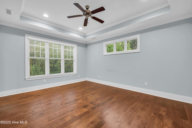 1115 Eldora Ct, Leland, NC 28451 - empty room featuring a raised ceiling, crown molding, dark wood finished floors, a ceiling fan, and baseboards