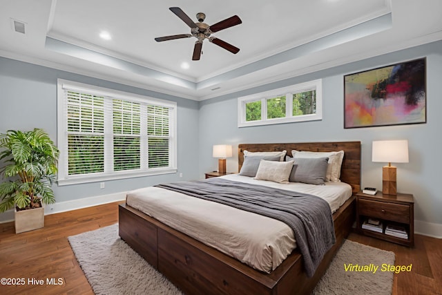 1115 Eldora Ct, Leland, NC 28451 - bedroom featuring a tray ceiling, baseboards, crown molding, wood finished floors, and recessed lighting
