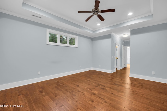 1115 Eldora Ct, Leland, NC 28451 - empty room featuring a raised ceiling, ornamental molding, ceiling fan, wood finished floors, and baseboards