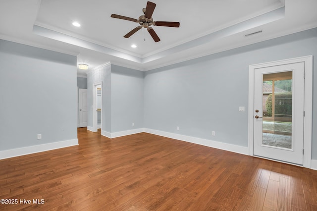 1115 Eldora Ct, Leland, NC 28451 - empty room featuring a tray ceiling, crown molding, ceiling fan, hardwood / wood-style floors, and recessed lighting