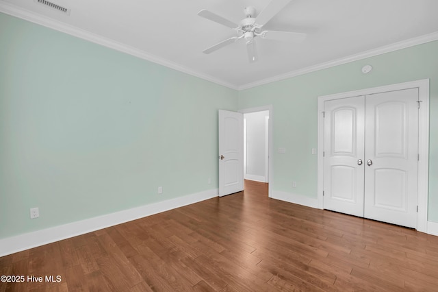 1115 Eldora Ct, Leland, NC 28451 - unfurnished bedroom featuring crown molding, baseboards, wood finished floors, a closet, and ceiling fan