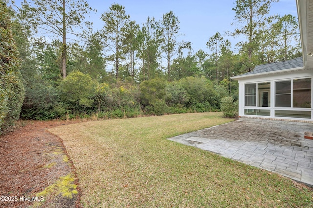 1115 Eldora Ct, Leland, NC 28451 - view of grassy yard featuring a sunroom and a patio