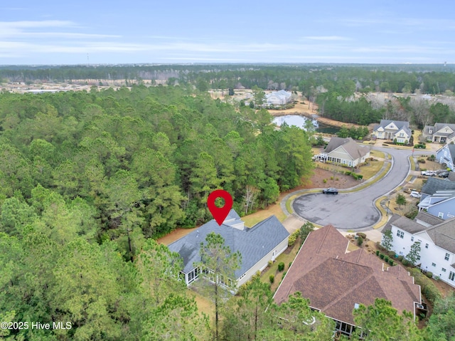 1115 Eldora Ct, Leland, NC 28451 - aerial view of property and surrounding area with nearby suburban area and a heavily wooded area