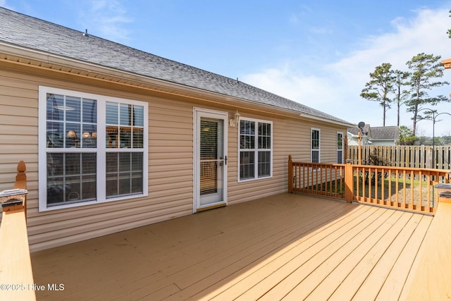 wooden terrace featuring fence