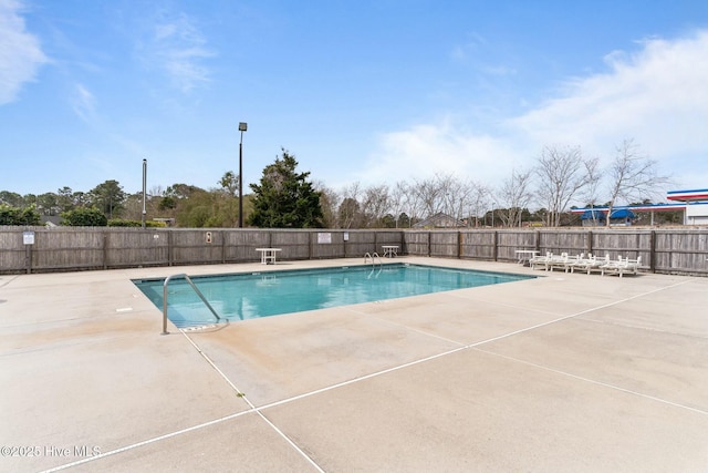 pool featuring a patio area and fence