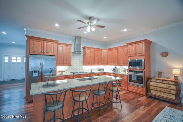 kitchen featuring a sink, dark wood-type flooring, appliances with stainless steel finishes, and wall chimney range hood