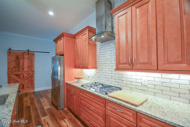 kitchen featuring ornamental molding, island exhaust hood, dark wood-style floors, a barn door, and appliances with stainless steel finishes