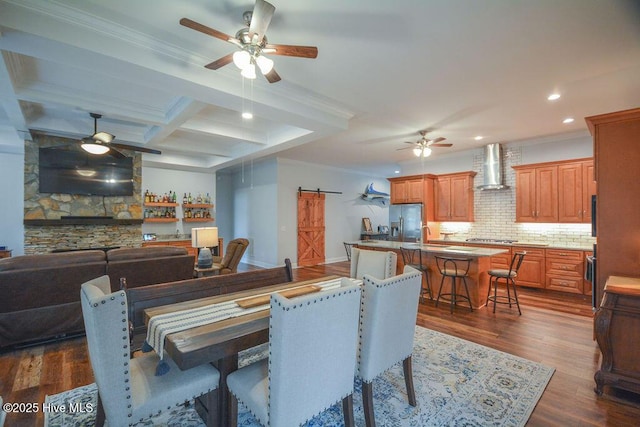 dining area with ceiling fan, dark wood finished floors, and ornamental molding