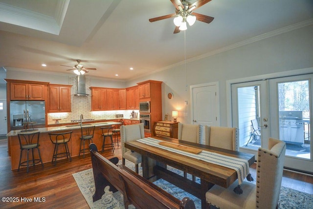 dining area featuring dark wood finished floors, recessed lighting, a ceiling fan, and ornamental molding