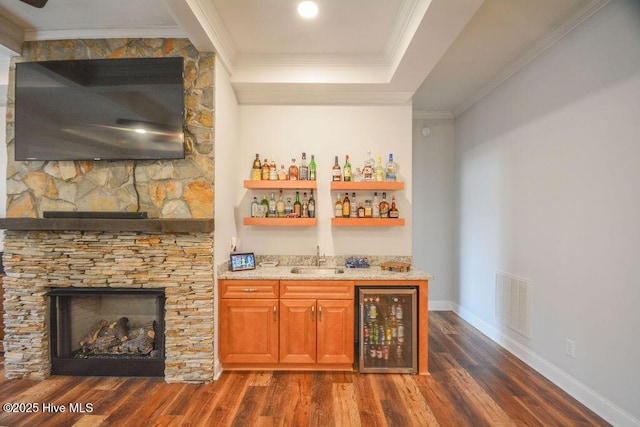 bar featuring visible vents, crown molding, wine cooler, indoor wet bar, and a sink