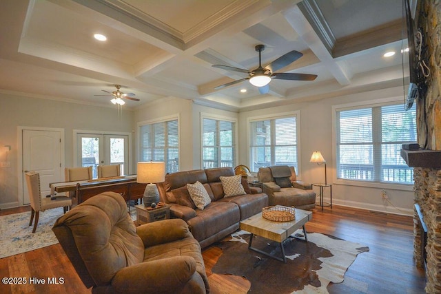 living area featuring beamed ceiling, wood finished floors, and ceiling fan