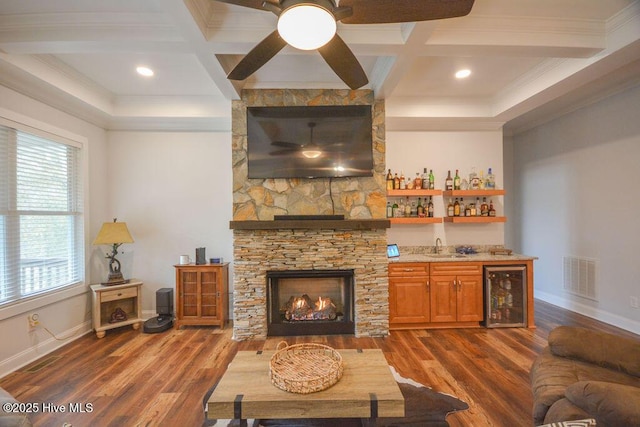 living area featuring visible vents, ceiling fan, wine cooler, a fireplace, and wet bar