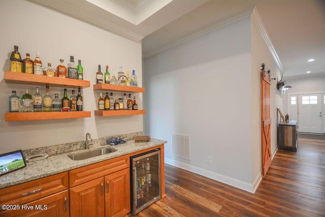 bar featuring visible vents, a sink, wine cooler, crown molding, and indoor wet bar