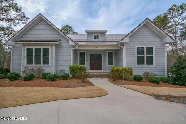 view of front of home featuring metal roof and a porch