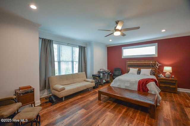 bedroom with baseboards, wood finished floors, and crown molding