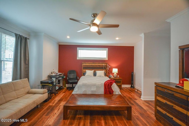 bedroom featuring ornamental molding, baseboards, and wood finished floors